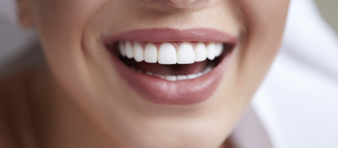 Healthy white smile close up. Beauty woman with perfect smile, lips and teeth. Beautiful Model Girl with perfect skin. Teeth whitening.