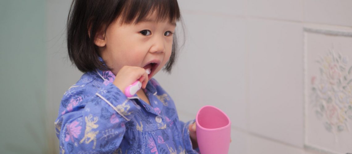 baby-girl-learn-how-to-brush-teeth-948699480_5184x3888-min